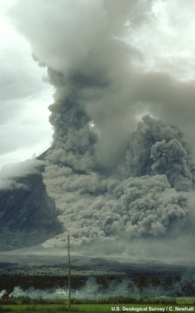 Pyroclastic flow sweeps down the side of Mayon Volcano, Philippines. Note the ground-hugging cloud of ash (lower left) that is billowing from the pyroclastic flow and the eruption column rising from the top of the volcano.
