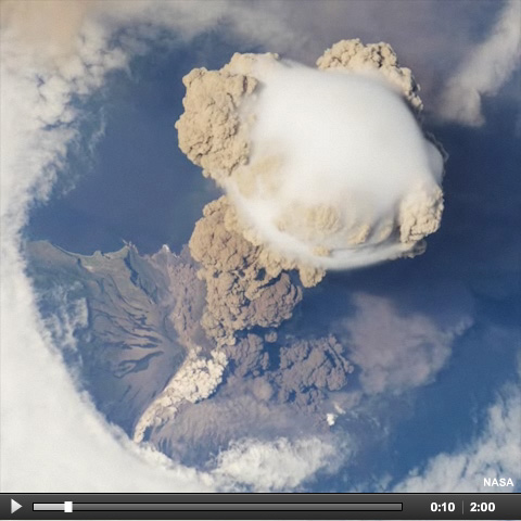 International Space Station view of Sarychev Volcano (Kuril Islands, northeast of Japan) in an early stage of eruption on June 12, 2009.  The ash plume is viewed from above and it has pierced the cloud cover above the volcano.  A pyroclastic flow is visible on the volcano's flank.