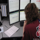 A woman 
studies a monitor at the Alaska and West Coast Tsunami Warning Center